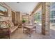 Inviting covered patio featuring brick columns, ceiling fan, and comfortable wicker seating, perfect for outdoor relaxation at 519 Donaldson Dr, Debary, FL 32713