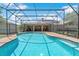 Beautiful backyard pool with screened enclosure, adjacent to the home's patio and offering a clear view of the property at 519 Donaldson Dr, Debary, FL 32713
