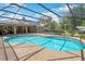Backyard pool with a screened enclosure, complemented by a spacious patio area for outdoor entertaining and relaxation at 519 Donaldson Dr, Debary, FL 32713