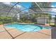 Inviting screened pool with a uniquely shaped design and ample deck space for lounging, perfect for summer enjoyment at 519 Donaldson Dr, Debary, FL 32713
