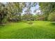 Enjoy a spacious, green backyard, perfect for recreation and relaxation at 5402 Turton Ln, Port Orange, FL 32127