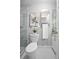 Bathroom with white fixtures, decorative accents, framed mirror, and marble-walled shower at 5402 Turton Ln, Port Orange, FL 32127