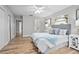 Spacious bedroom featuring a comfortable bed, ceiling fan, and two windows with closet at 5402 Turton Ln, Port Orange, FL 32127