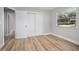 Bright bedroom featuring a closet, window with blinds, and hardwood flooring at 5402 Turton Ln, Port Orange, FL 32127