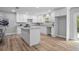 Bright kitchen featuring white cabinets, granite countertops, a kitchen island, and modern lighting at 5402 Turton Ln, Port Orange, FL 32127