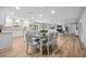 Open-concept living area seamlessly connecting dining and kitchen, featuring hardwood floors, recessed lighting, and modern finishes at 5402 Turton Ln, Port Orange, FL 32127