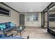 Cozy screened-in porch featuring a comfortable seating area, creating a peaceful space for relaxation and enjoyment at 5402 Turton Ln, Port Orange, FL 32127