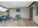 Inviting screened-in porch with comfortable seating, ideal for relaxing and enjoying the outdoors at 5402 Turton Ln, Port Orange, FL 32127