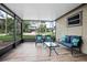 Relaxing screened-in porch with stylish furniture, offering a comfortable space to unwind and enjoy the scenery at 5402 Turton Ln, Port Orange, FL 32127