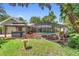 Large backyard featuring a screened pool, hot tub, and outdoor seating area at 552 Hamlet Dr, Port Orange, FL 32127