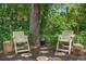 The backyard includes a cozy outdoor seating area with chairs and a small grill at 552 Hamlet Dr, Port Orange, FL 32127