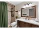 Well-lit bathroom features a shower with green curtains and a modern vanity sink at 552 Hamlet Dr, Port Orange, FL 32127