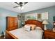 Cozy bedroom featuring warm lighting, wood furniture, and comfortable furnishings at 552 Hamlet Dr, Port Orange, FL 32127