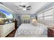 Comfortable bedroom with a queen-size bed, a ceiling fan, and a TV at 552 Hamlet Dr, Port Orange, FL 32127
