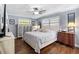 Tranquil bedroom featuring wood floors, a ceiling fan, and elegant decor at 552 Hamlet Dr, Port Orange, FL 32127