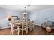 Traditional dining room with a large wood table, blue walls, and a chandelier at 552 Hamlet Dr, Port Orange, FL 32127