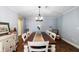 Dining room with wood table, seating for eight, wood flooring and soft blue walls at 552 Hamlet Dr, Port Orange, FL 32127