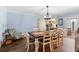 Cozy dining room with wood table, seating for eight, and view into the kitchen at 552 Hamlet Dr, Port Orange, FL 32127