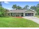 Charming one-story home with well-manicured lawn and mature trees at 552 Hamlet Dr, Port Orange, FL 32127