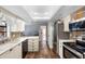 Bright kitchen with updated stainless steel appliances, stone backsplash, and plenty of cabinet space at 552 Hamlet Dr, Port Orange, FL 32127