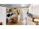 Well-organized laundry room with modern washer/dryer, workspace and a convenient door to the exterior at 552 Hamlet Dr, Port Orange, FL 32127