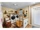 Functional laundry room featuring washer and dryer with workspace, and outdoor access at 552 Hamlet Dr, Port Orange, FL 32127