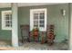 Welcoming front porch featuring rocking chairs and tiled flooring adding to the cozy, inviting atmosphere of the home at 552 Hamlet Dr, Port Orange, FL 32127