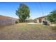 Large backyard with a wooden fence, grassy area, concrete patio, and room for outdoor living at 5825 Forest Grove Blvd, Orlando, FL 32808