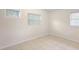 Bedroom features neutral walls, tile floors, base molding and two windows at 5825 Forest Grove Blvd, Orlando, FL 32808