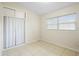 A bright bedroom is enhanced by natural light, complemented by tiled floors and ample closet space at 5825 Forest Grove Blvd, Orlando, FL 32808