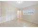 A bright, tiled floor bedroom features natural light, a closet and an ensuite bathroom entrance at 5825 Forest Grove Blvd, Orlando, FL 32808