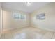 Bedroom features tile floors, neutral walls, base molding and two windows at 5825 Forest Grove Blvd, Orlando, FL 32808
