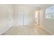 A clean, bright bedroom features a closet and tiled floor with access to the bathroom at 5825 Forest Grove Blvd, Orlando, FL 32808
