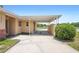 Covered carport is attached to this single-story home, with open parking and views of the neighborhood at 5825 Forest Grove Blvd, Orlando, FL 32808