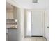 The entryway has light tile floors and access to the kitchen with granite countertop and mosaic backsplash at 5825 Forest Grove Blvd, Orlando, FL 32808