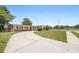 This single-story home has a long driveway, covered parking, and landscaping around the perimeter at 5825 Forest Grove Blvd, Orlando, FL 32808