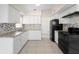 Well-lit kitchen with white cabinets, stainless steel appliances, and a tile backsplash at 5825 Forest Grove Blvd, Orlando, FL 32808