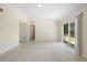 Bright living area with tile flooring, neutral walls, and sliding glass doors to backyard at 5825 Forest Grove Blvd, Orlando, FL 32808