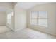 Bright living area offers tile flooring, neutral paint, and a large window for ample natural light at 5825 Forest Grove Blvd, Orlando, FL 32808