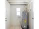 This utility room has white walls, tile floor, water heater, and window for natural light at 5825 Forest Grove Blvd, Orlando, FL 32808