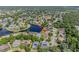 Aerial view of the home nestled in a lush neighborhood with a beautiful lake nearby at 6083 Sabal Hammock Cir, Port Orange, FL 32128