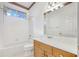 Bright bathroom featuring a white tiled shower, a large mirror, and a light wood vanity at 6083 Sabal Hammock Cir, Port Orange, FL 32128