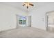 Bright bedroom featuring a ceiling fan and sliding glass doors that lead to a screened-in pool area at 6083 Sabal Hammock Cir, Port Orange, FL 32128
