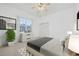 Staged bedroom with a cozy bed, modern dresser, and decor at 6083 Sabal Hammock Cir, Port Orange, FL 32128