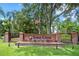 Elegant Sabal Creek community entrance with brick pillars, a wrought iron fence, and manicured landscaping at 6083 Sabal Hammock Cir, Port Orange, FL 32128