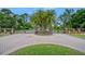 Grand gated entrance to the community featuring brick columns, iron gates, and palm tree landscaping at 6083 Sabal Hammock Cir, Port Orange, FL 32128