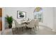 Bright dining room with a decorative window, an elegant marble table with seating for six at 6083 Sabal Hammock Cir, Port Orange, FL 32128