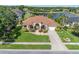 Beautiful one-story home with lush landscaping and a serene lake view creating an inviting curb appeal at 6083 Sabal Hammock Cir, Port Orange, FL 32128