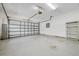 Spacious garage with an open door, storage shelves, and lighting, providing ample parking and storage at 6083 Sabal Hammock Cir, Port Orange, FL 32128