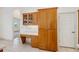 Kitchen featuring wooden cabinets, a built-in desk, and a large pantry at 6083 Sabal Hammock Cir, Port Orange, FL 32128